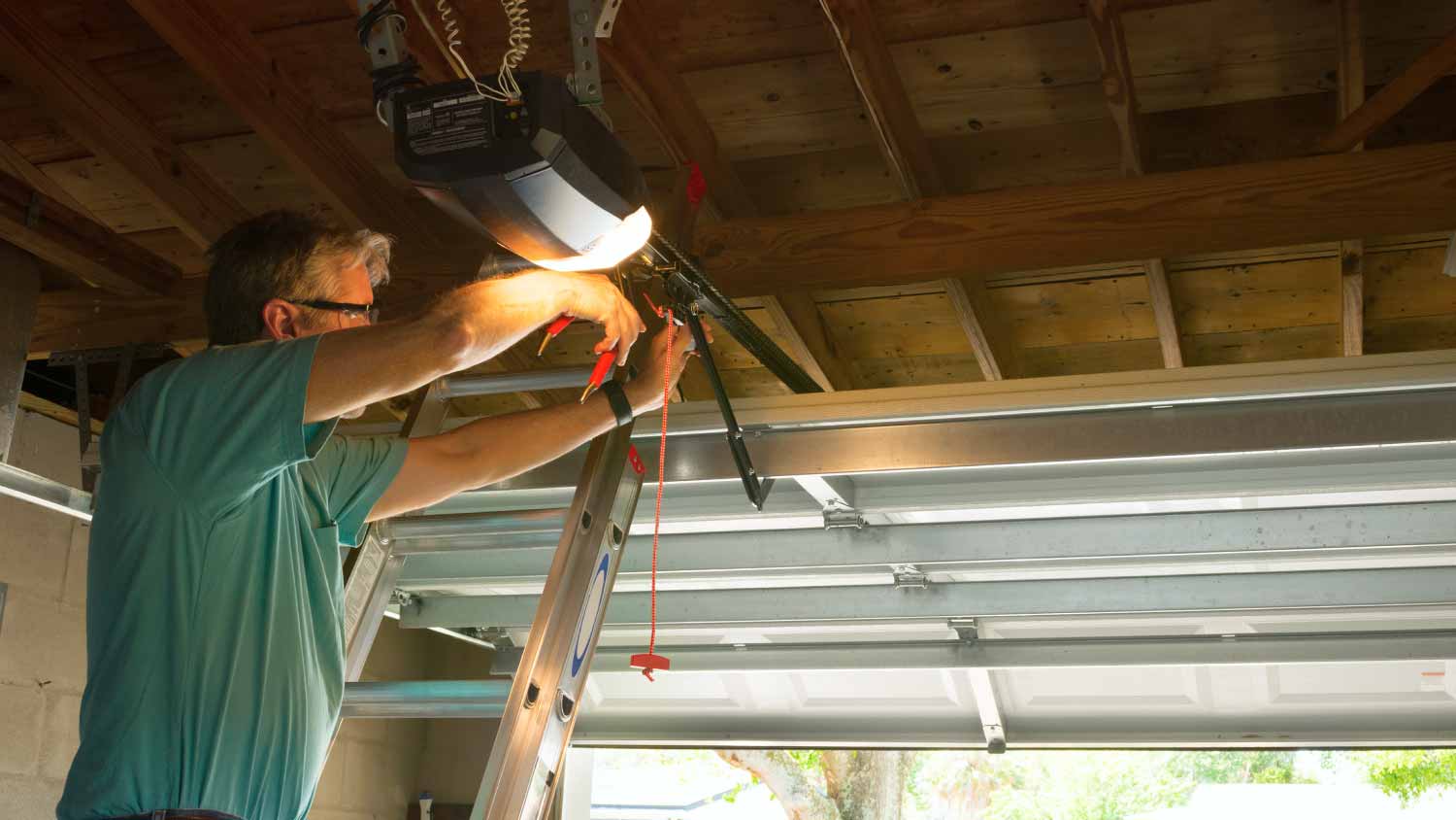 Man fixing automatic garage door