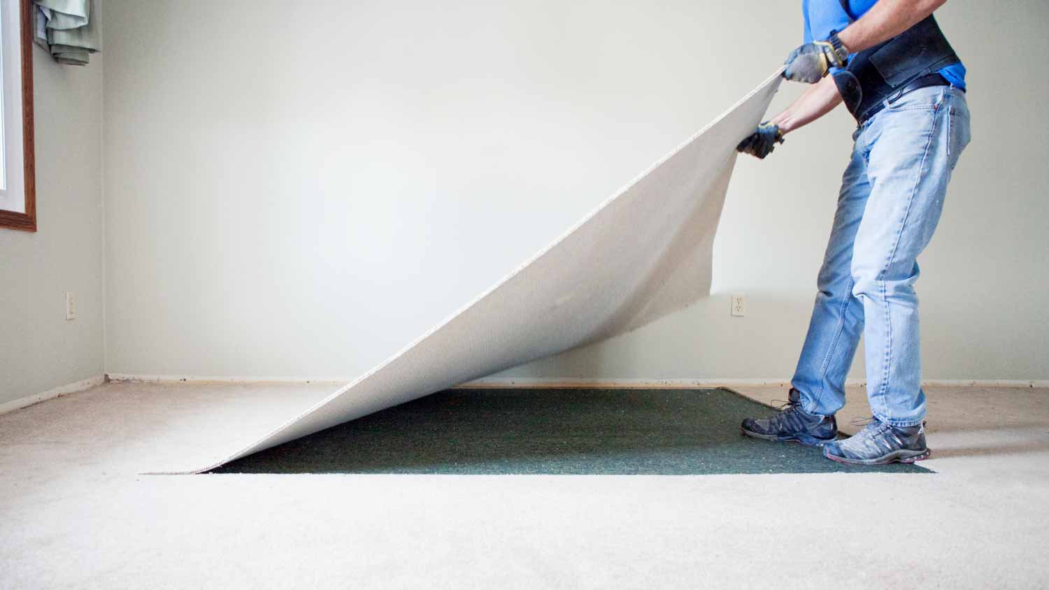 Man removing carpet