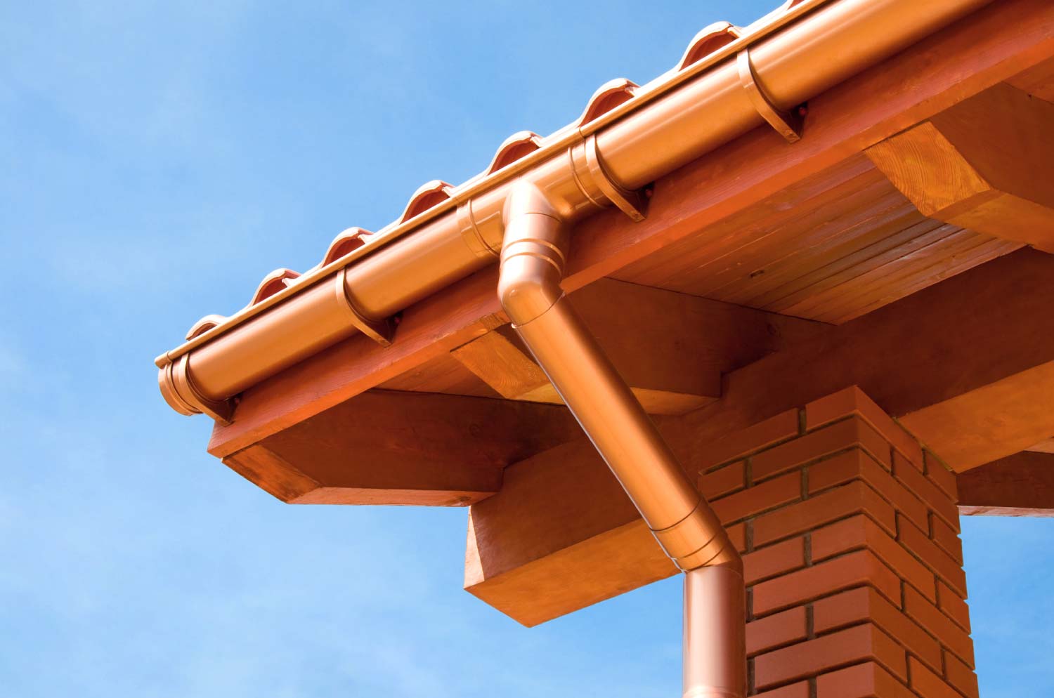 A close up of a copper gutter system