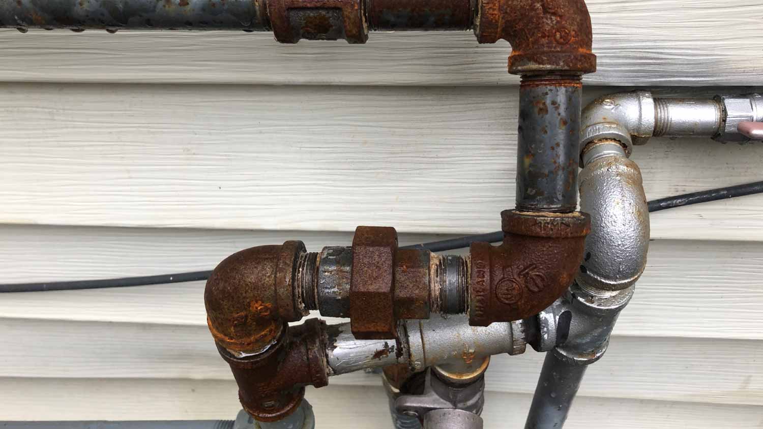 Rusted pipe outside house