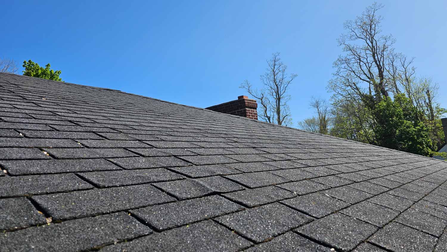 Shingled roof by chimney