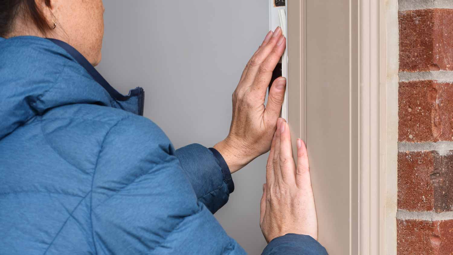 Woman attaching insulation strip