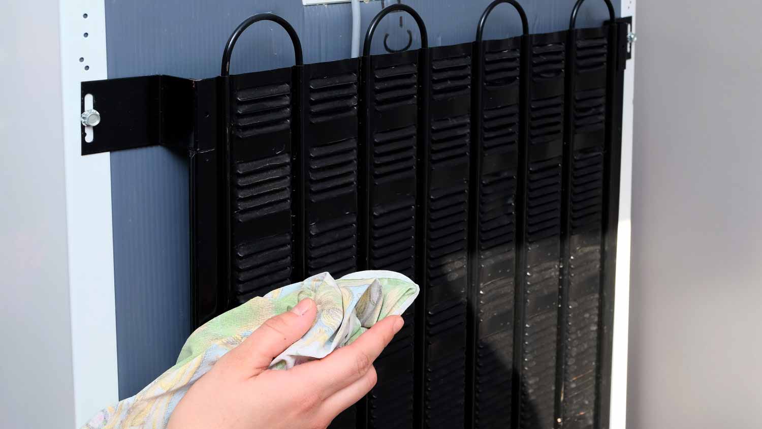 Woman cleaning condenser coils
