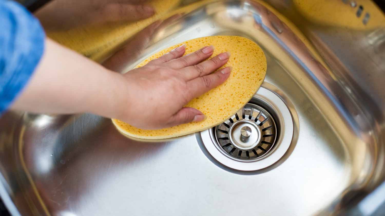 Woman cleaning sink