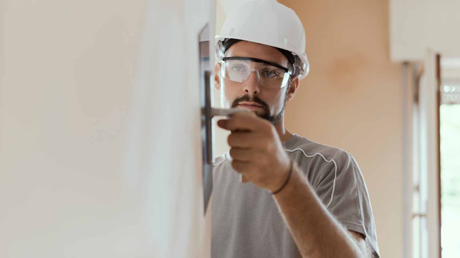 Worker applying plaster with a trowel
