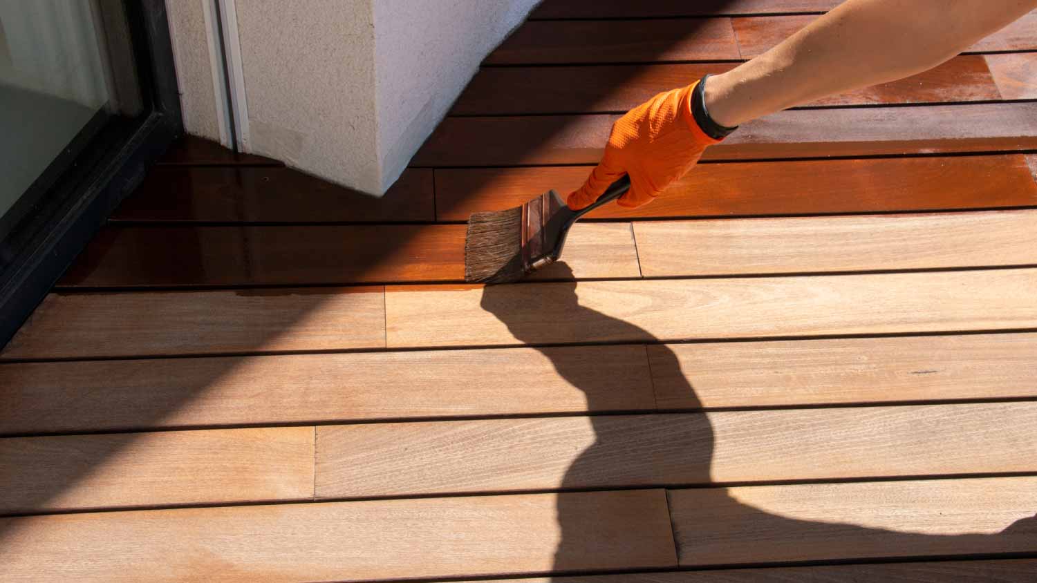 Worker applying stain