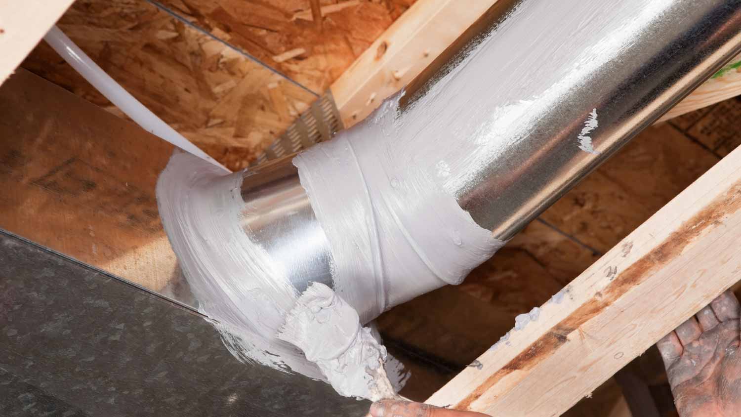 Worker sealing air duct with Latex Sealant