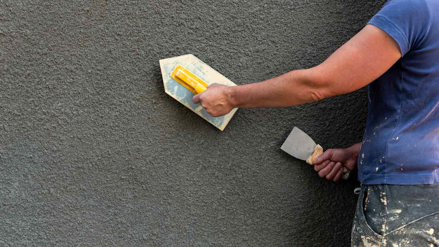 professional applying plaster to home exterior