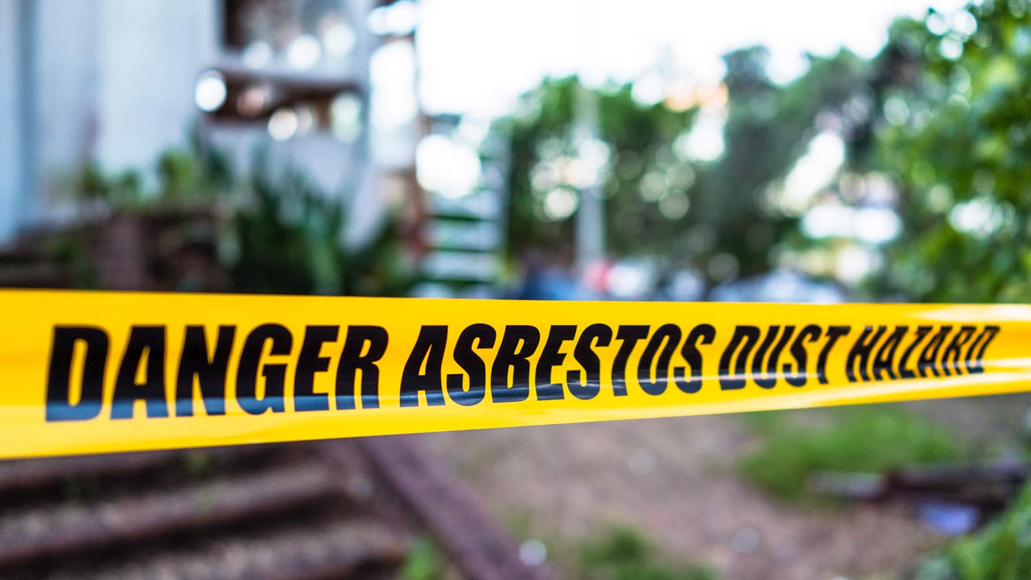 asbestos caution tape near house