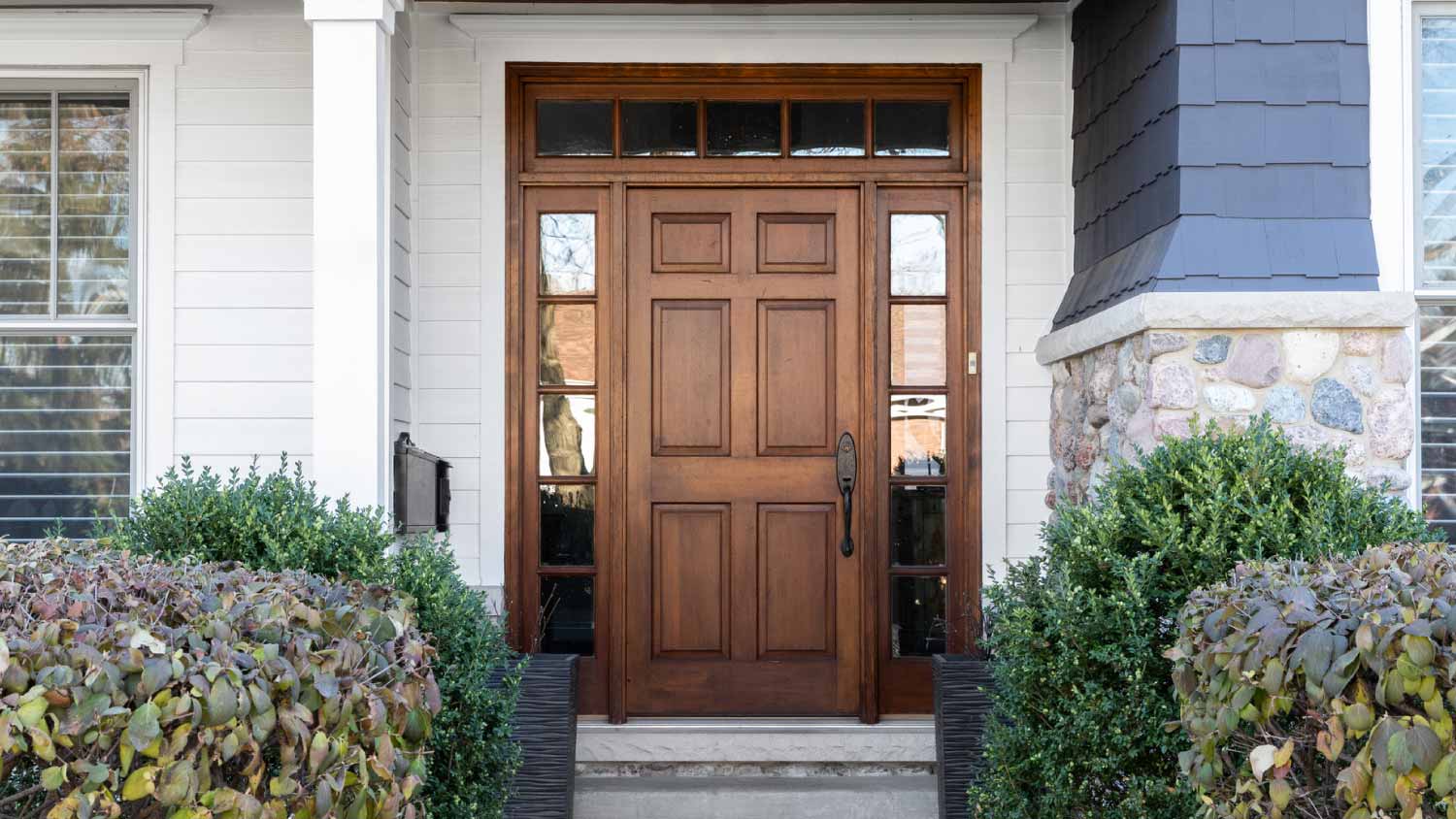 A blue house with a wooden front door