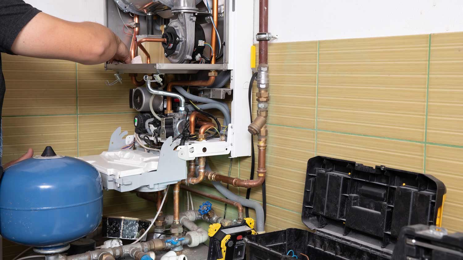 man repairing boiler