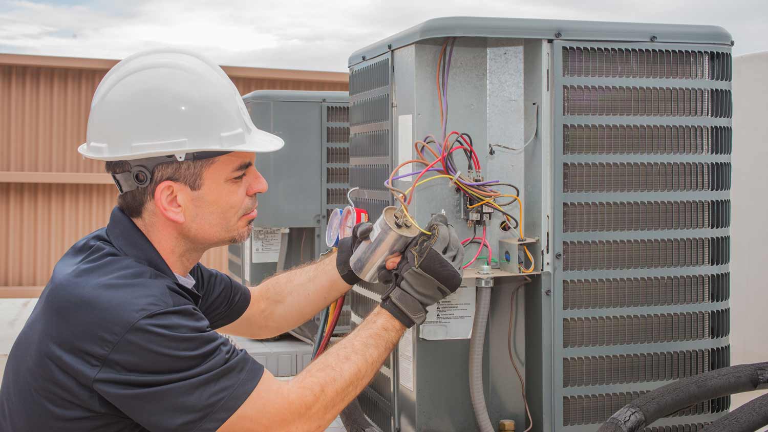 technician fixing ac capacitor