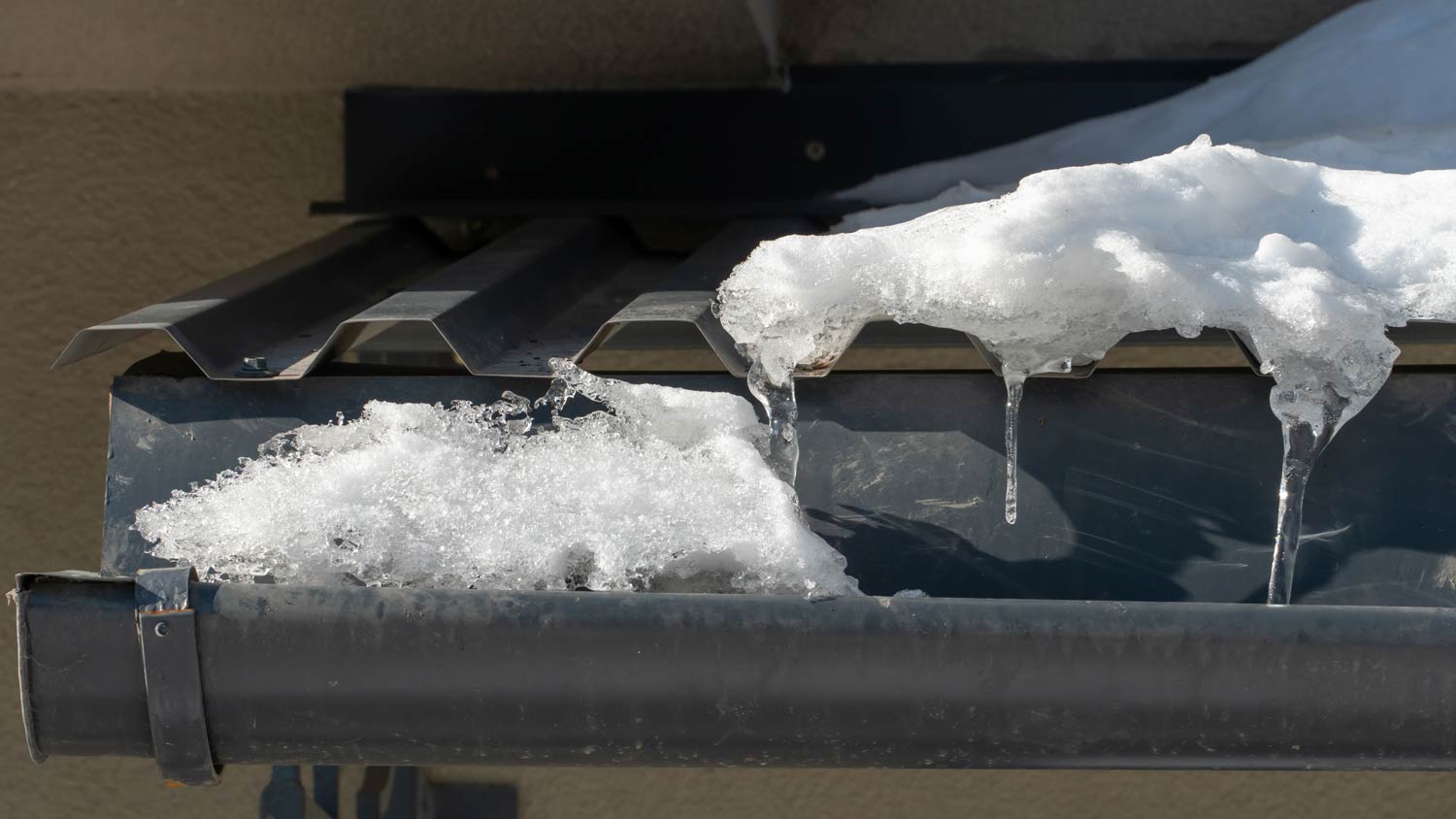 metal gutter covered with ice and snow