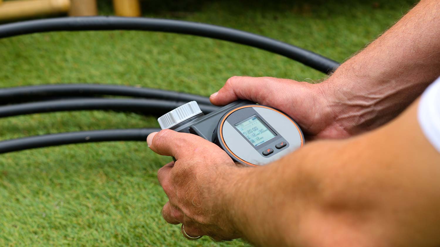 man holding irrigation timer for sprinkler