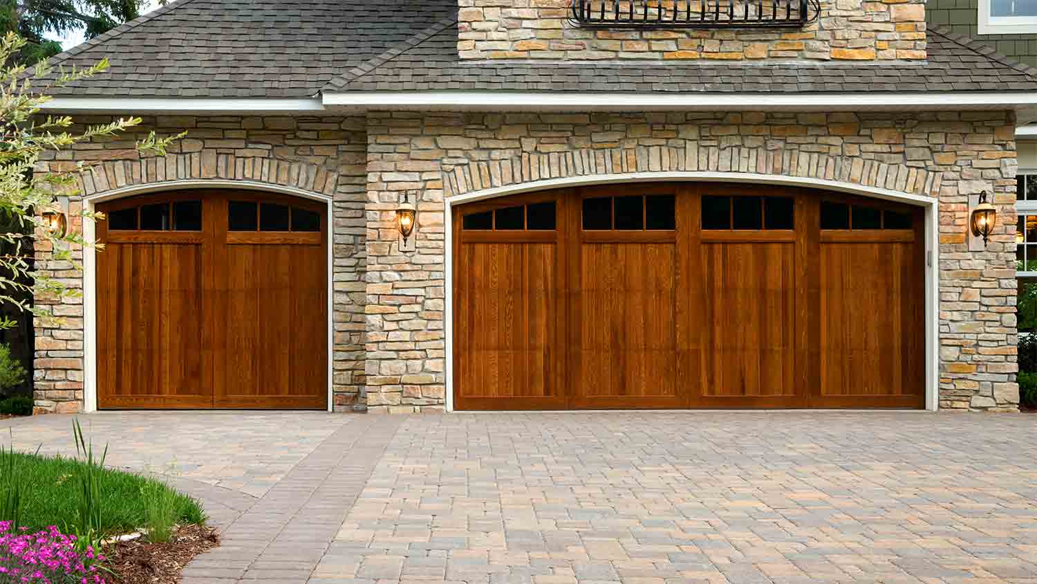 stone home with paver  driveway