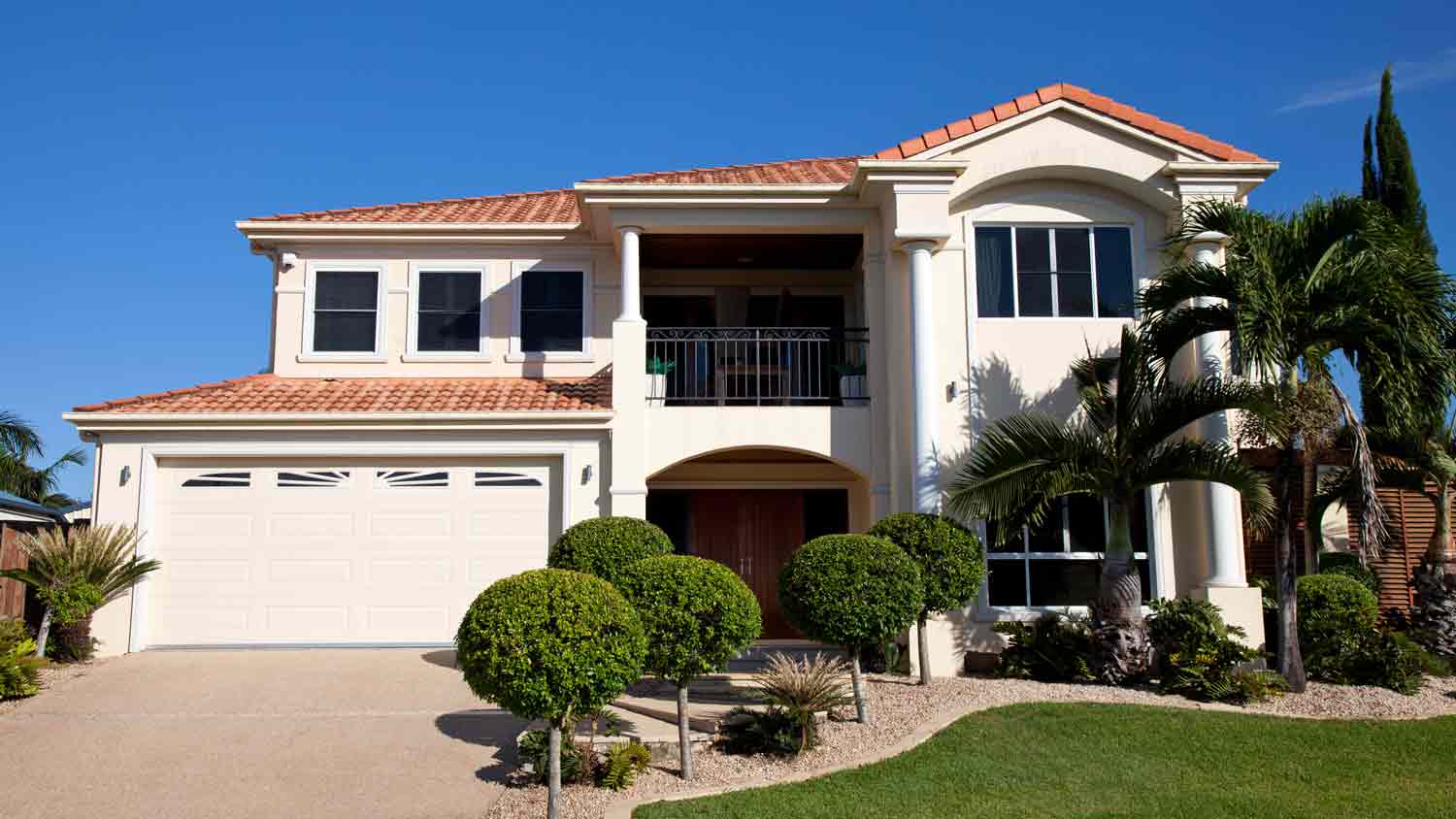 beige home with terracotta roof