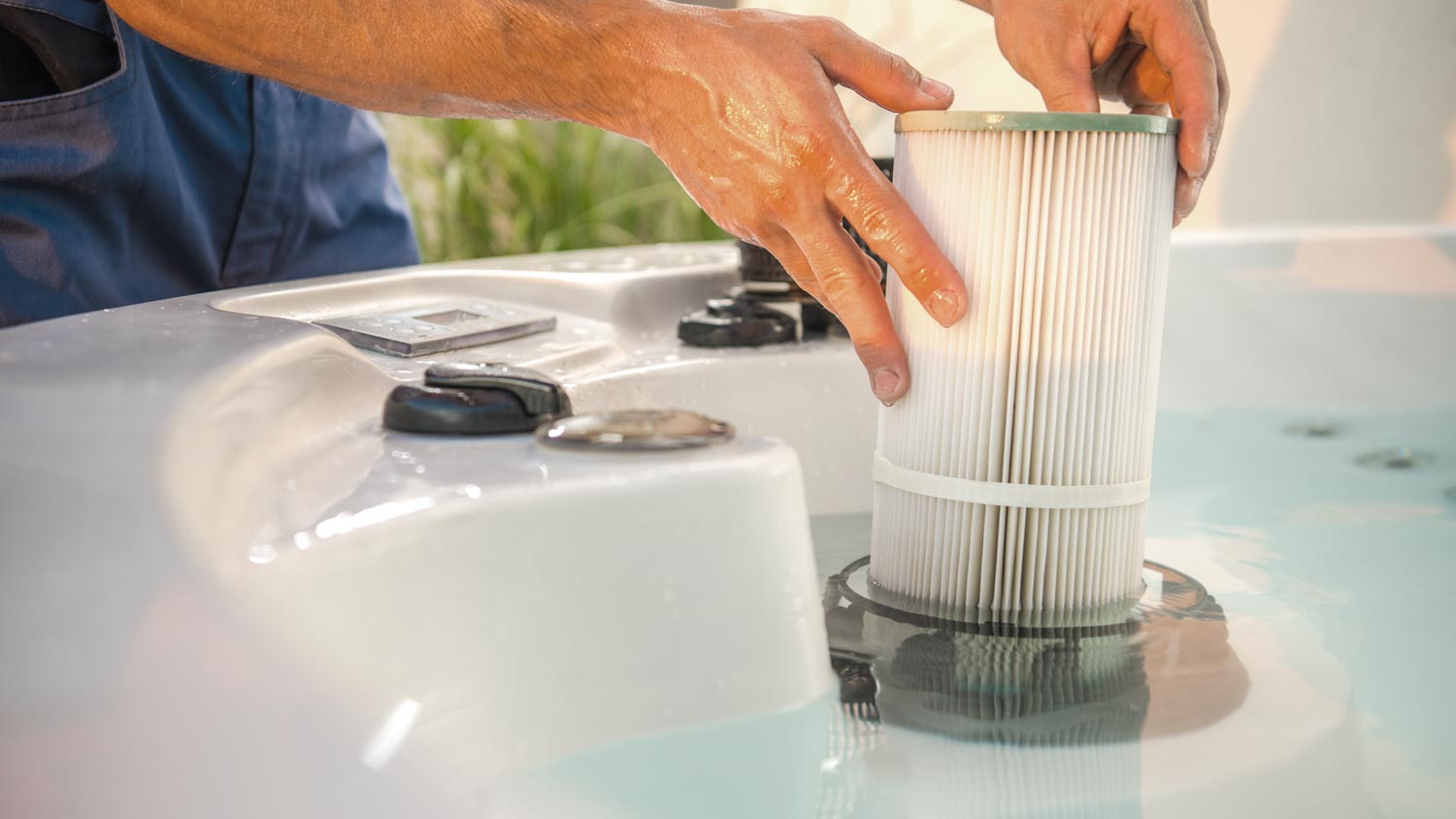 man changing hot tub filter