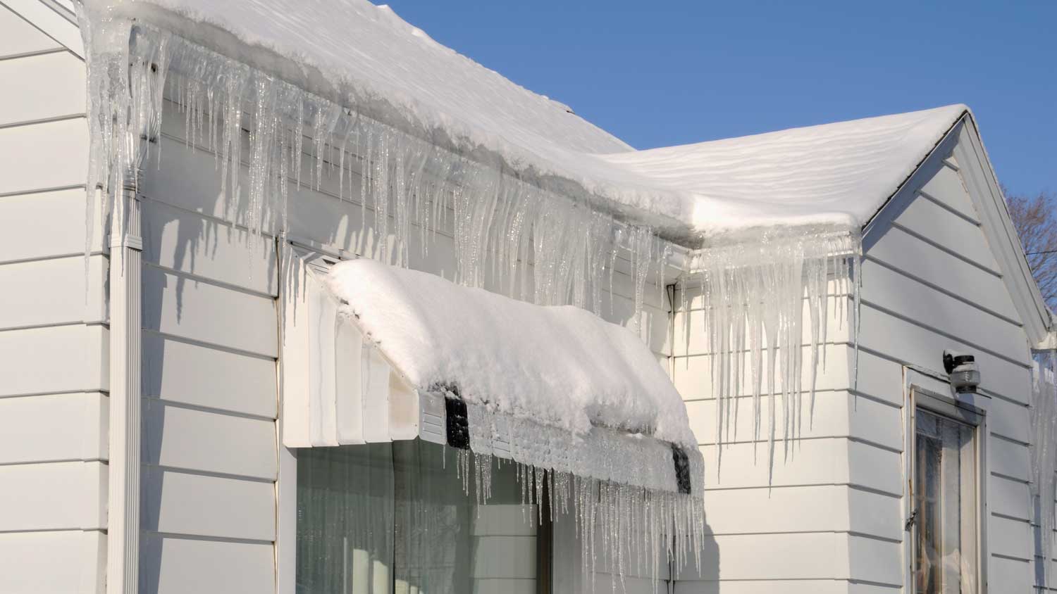 ice dams on roof of white house 