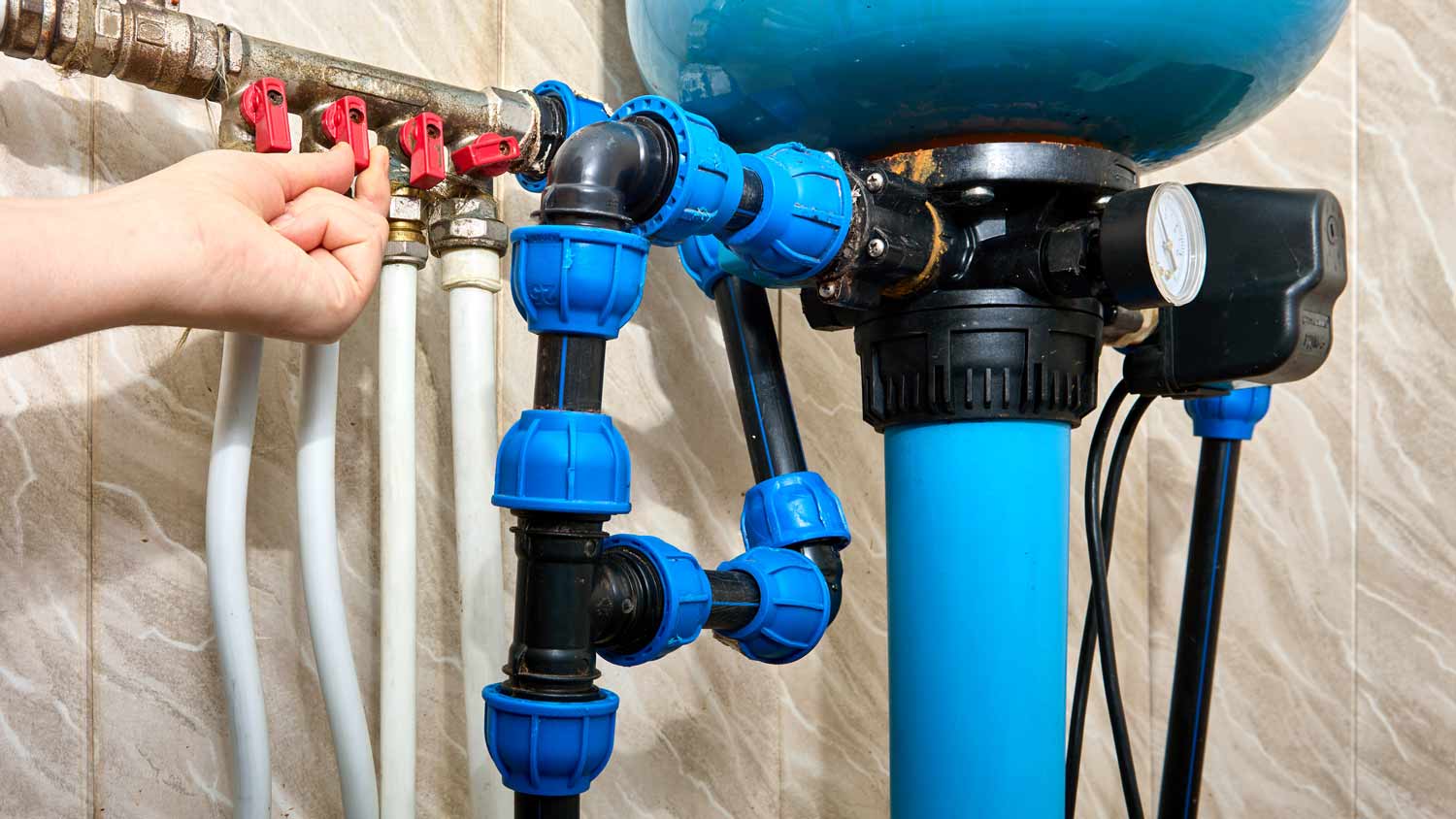 man installing house air filtration system