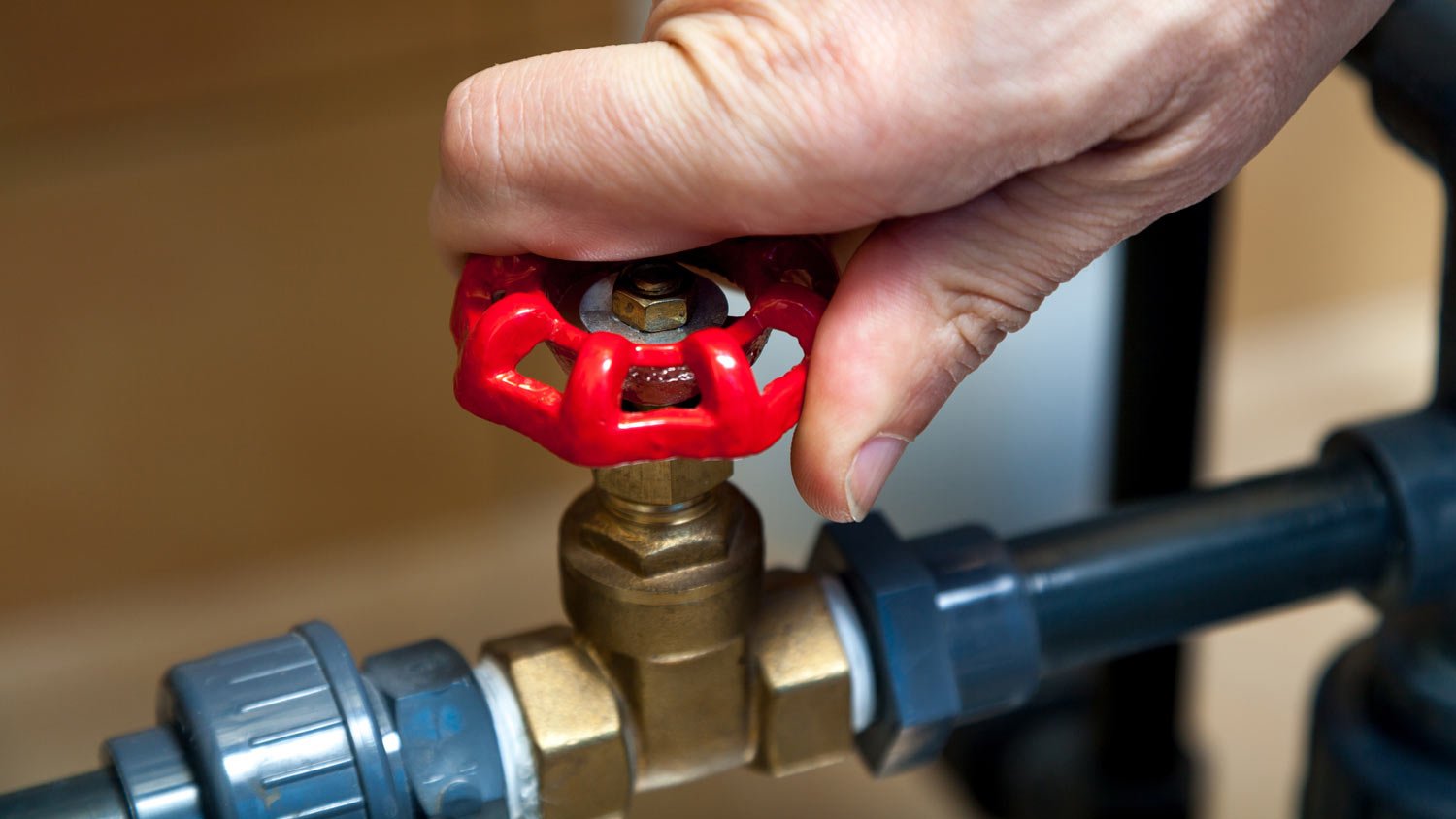 man closing valve