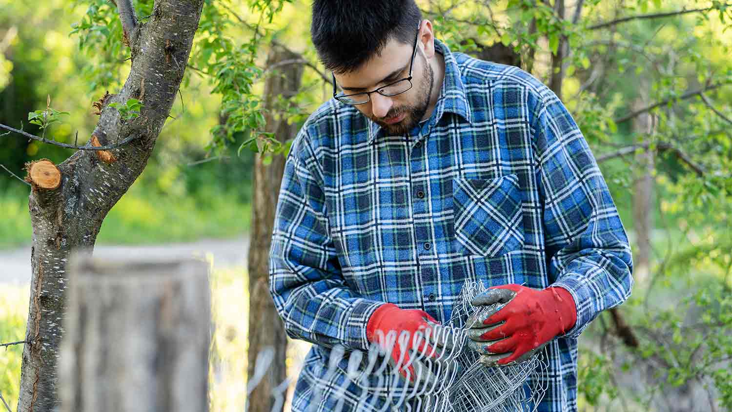 man holding chain link fence