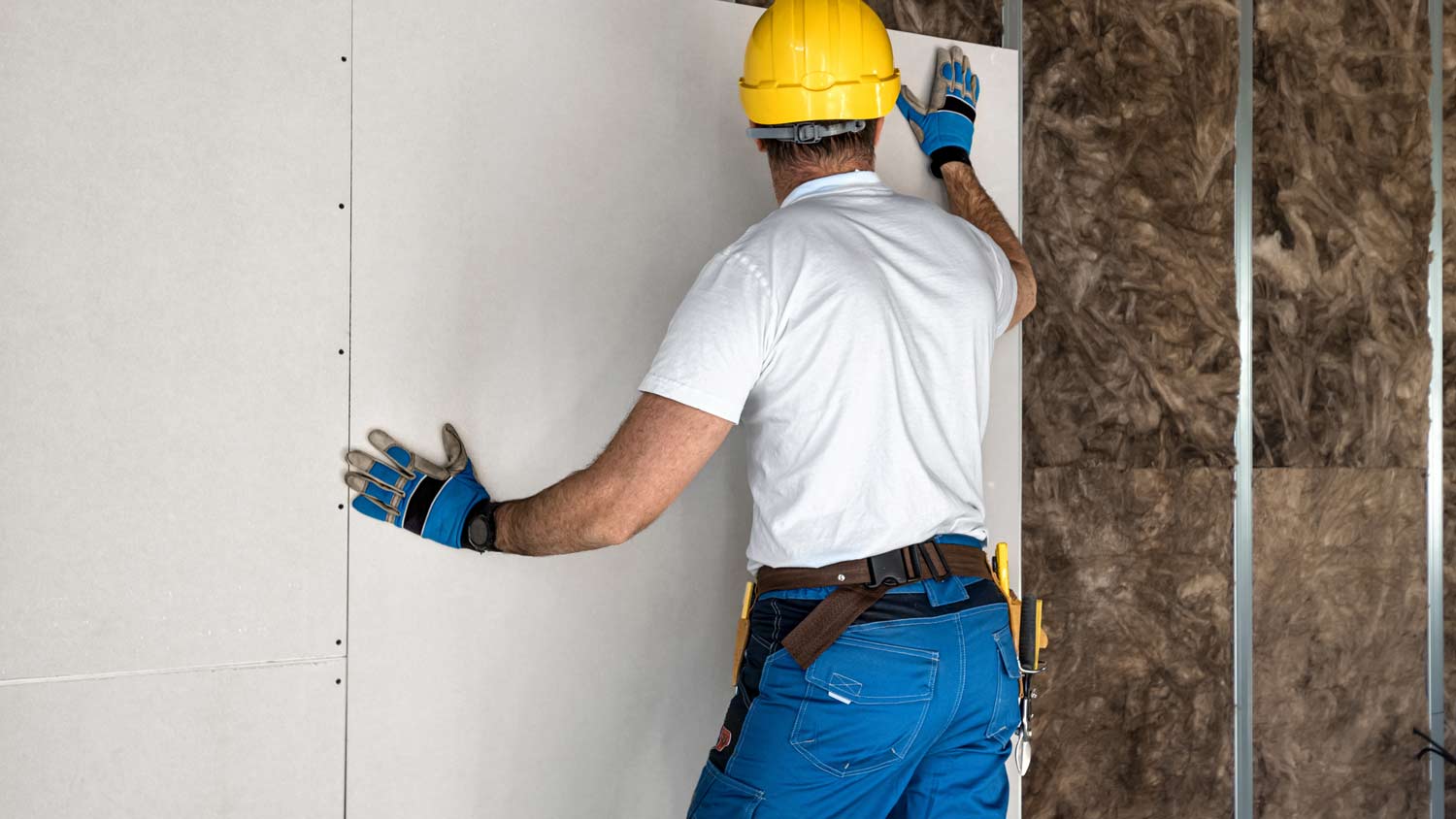 man installing drywall