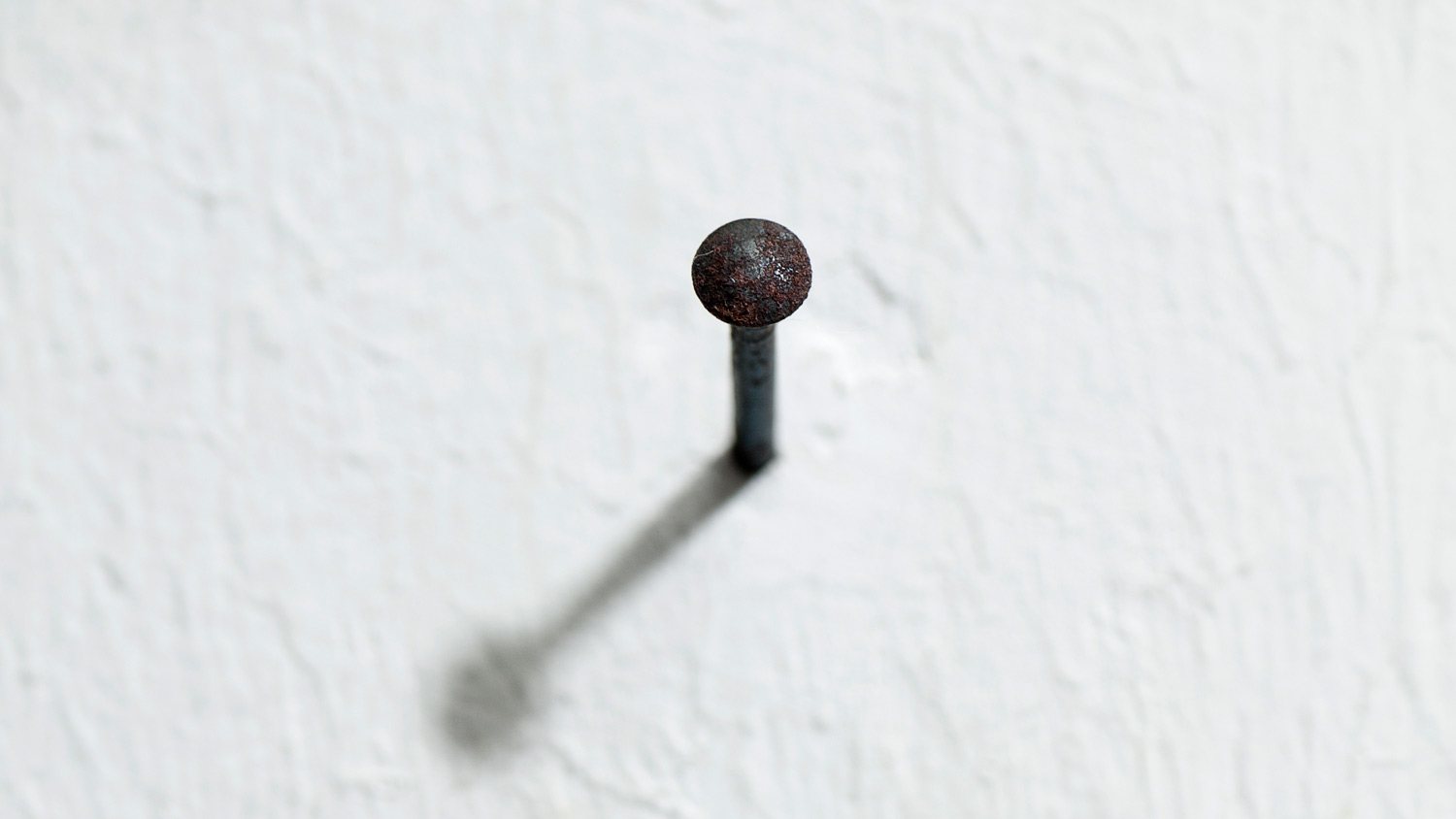 close up of nail in wall