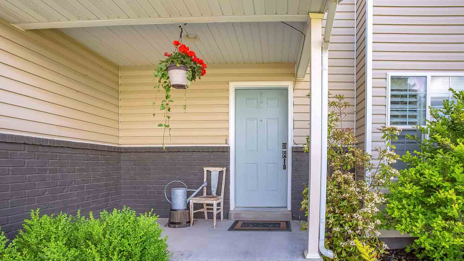 beige home with pastel blue door 