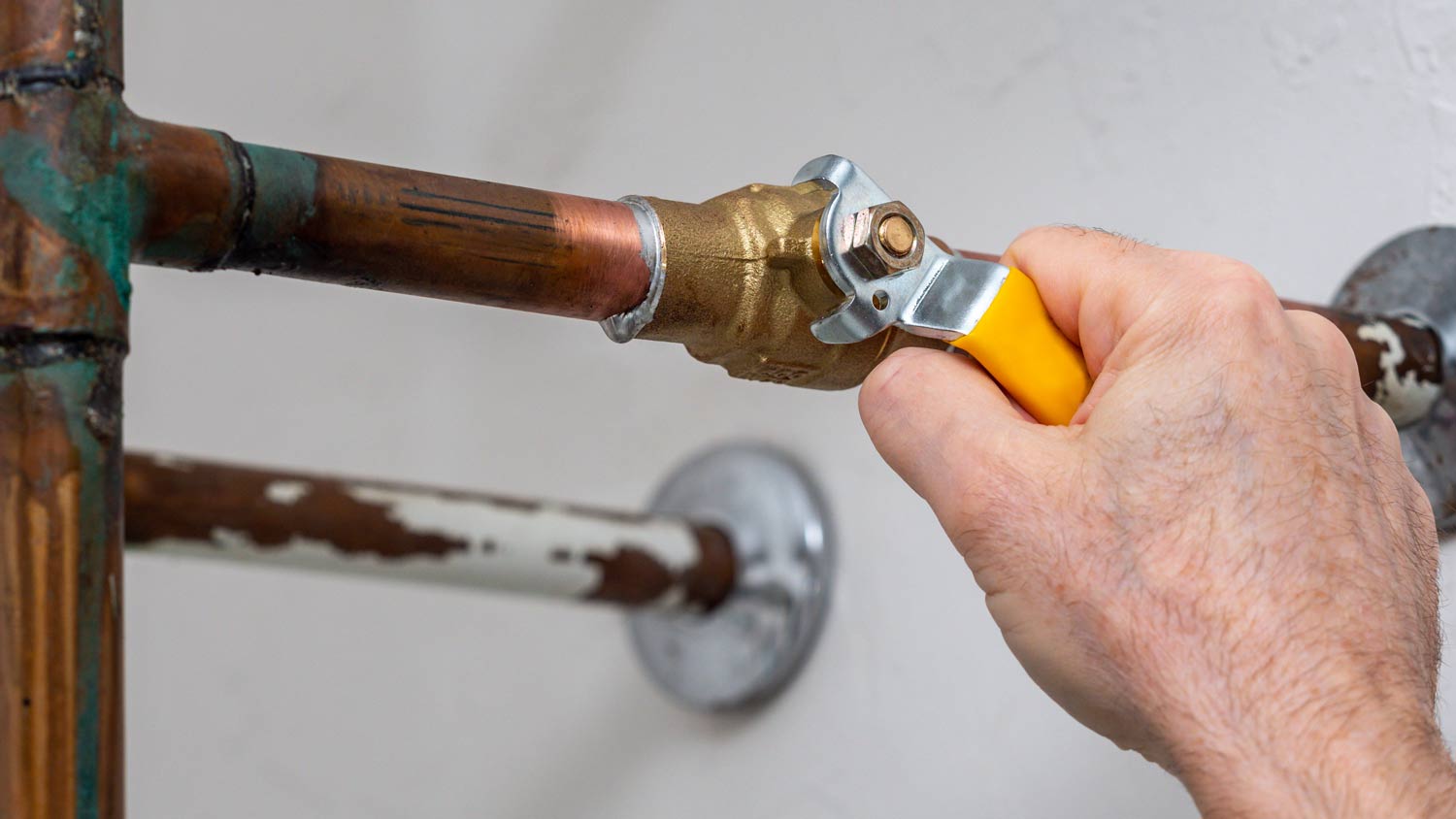 plumber removing lead pipe