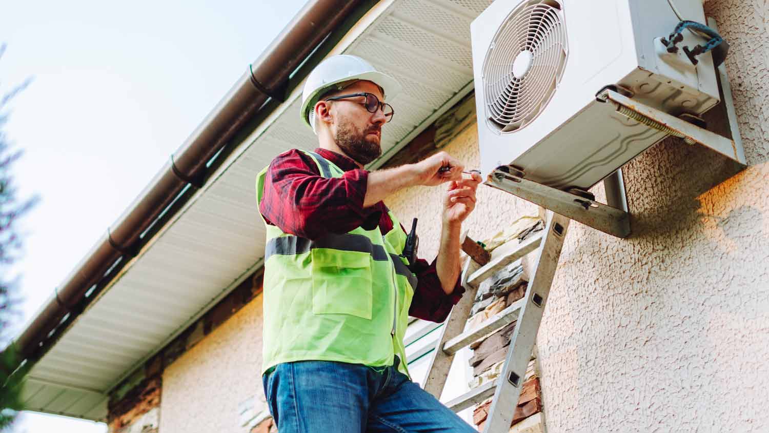 technician repairing heat pump