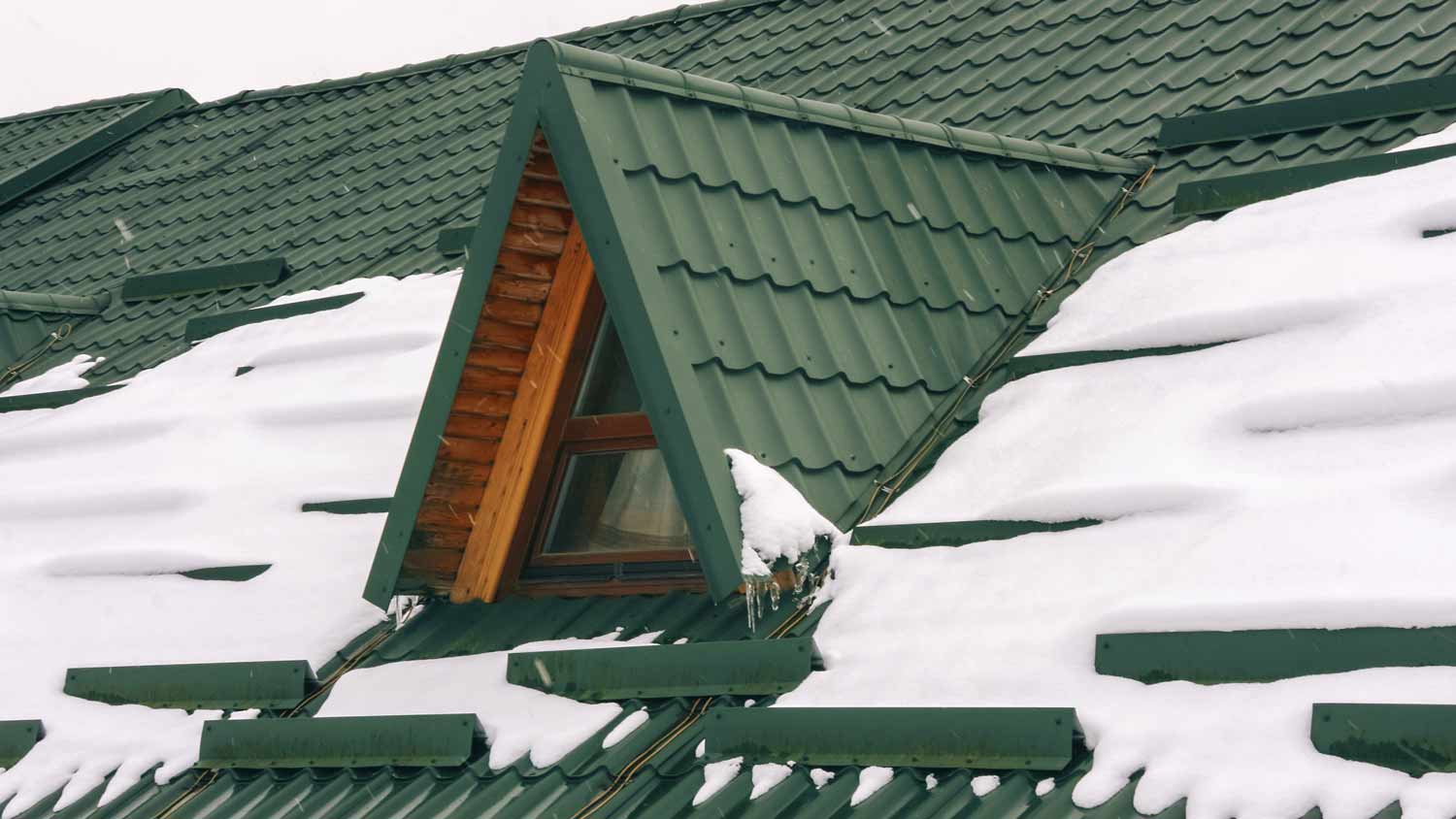 snow on tiled metal roof  