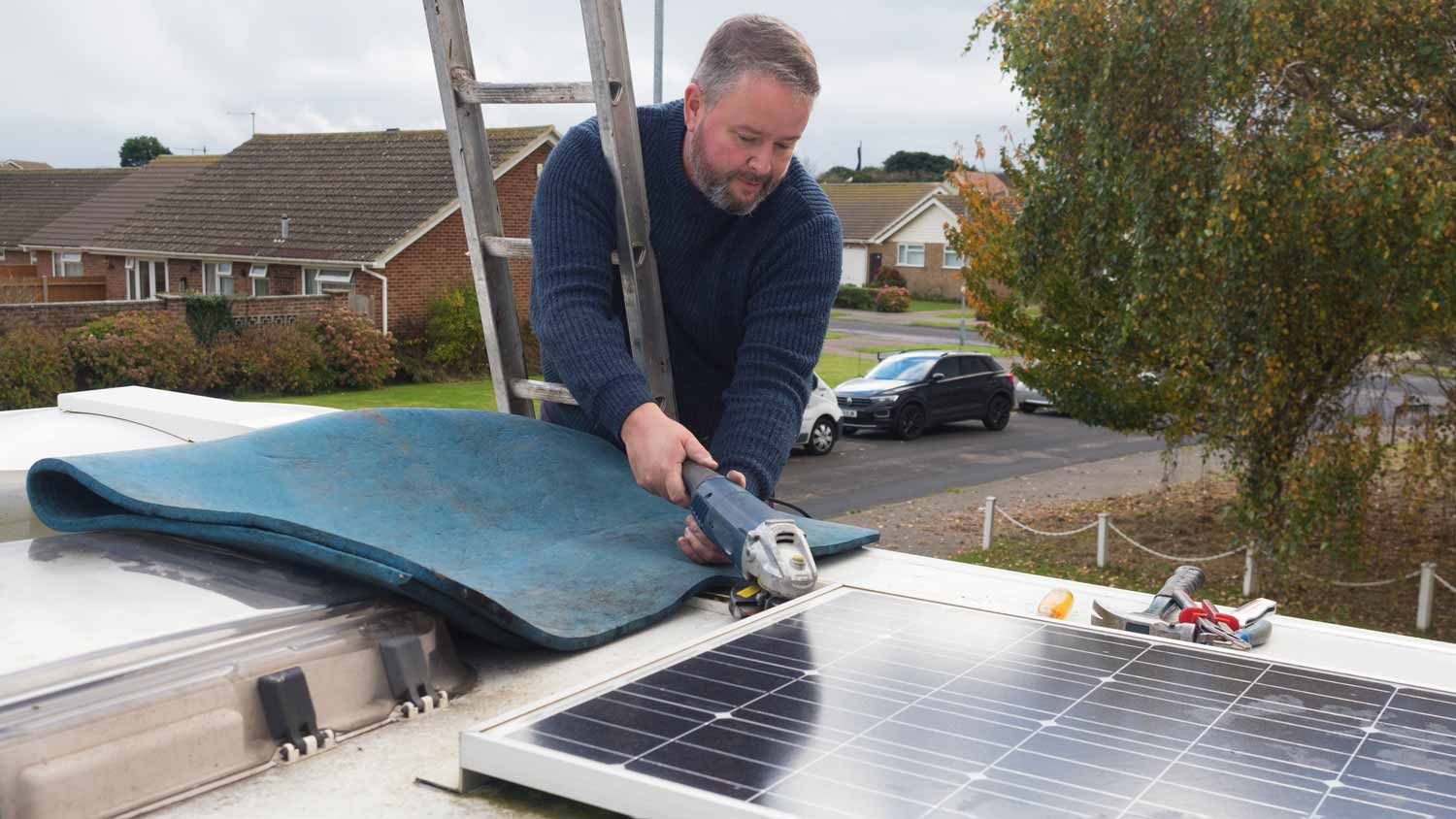 man removing solar panels from roof