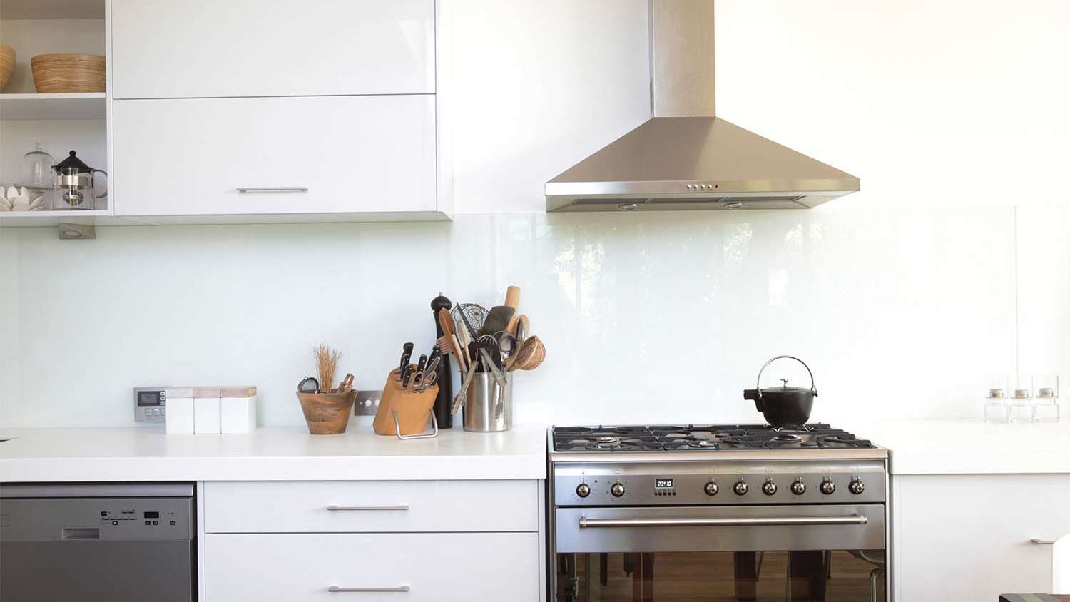 stainless stove and range hood in kitchen