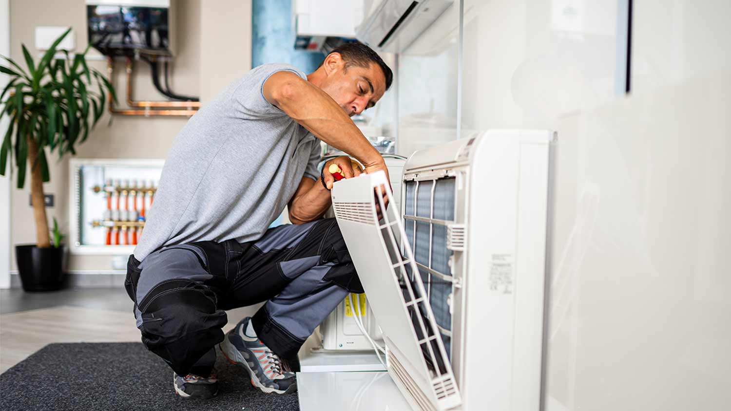 technician cleaning ac air filter