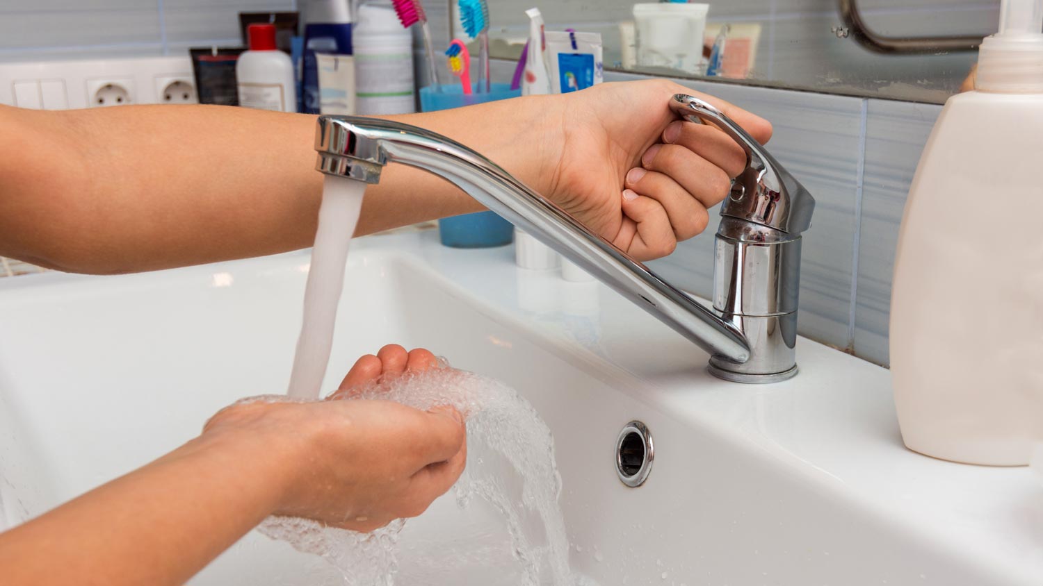 washing hand in bathroom sink