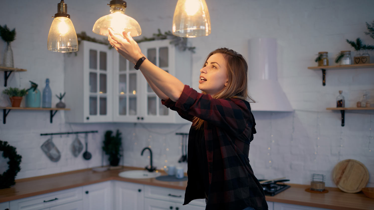 Woman changing lightbulb