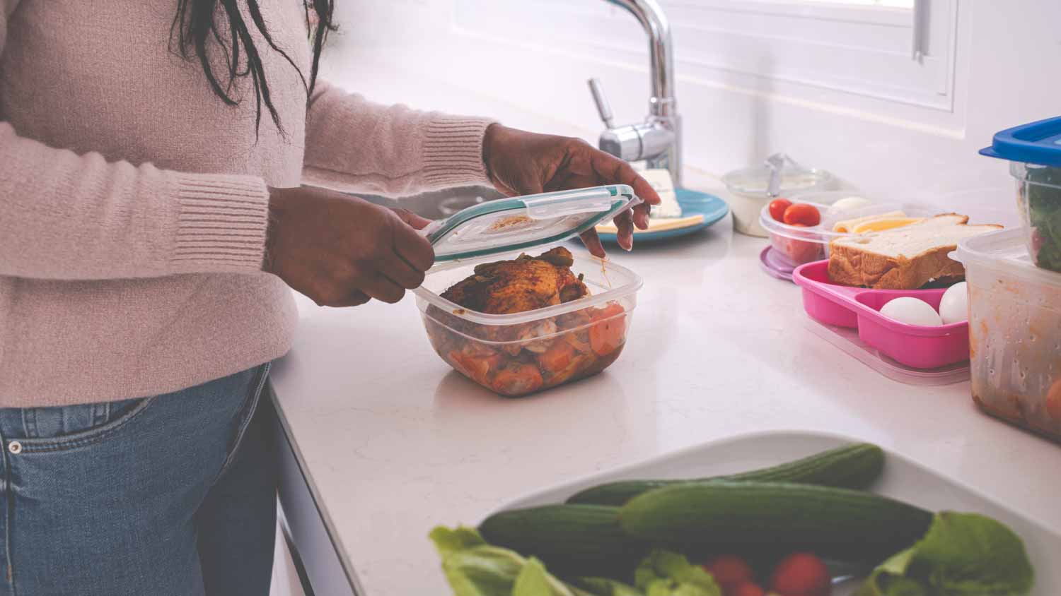 Woman packing leftovers food