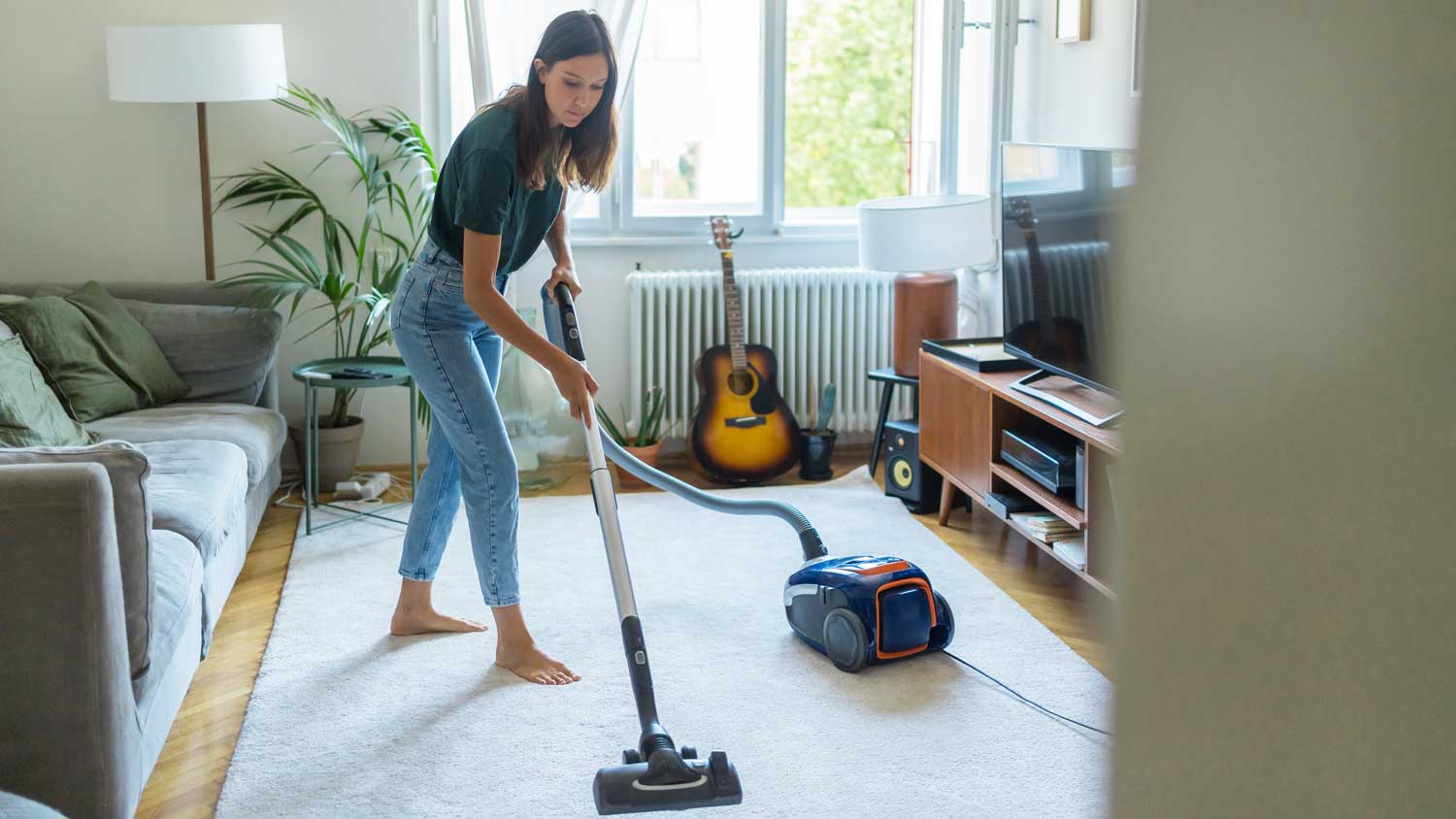 woman vacuuming rug