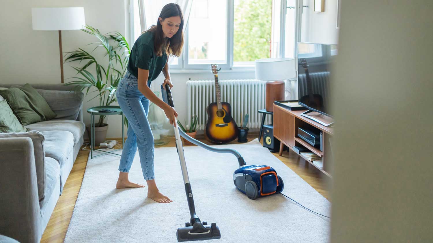  woman vacuuming rug