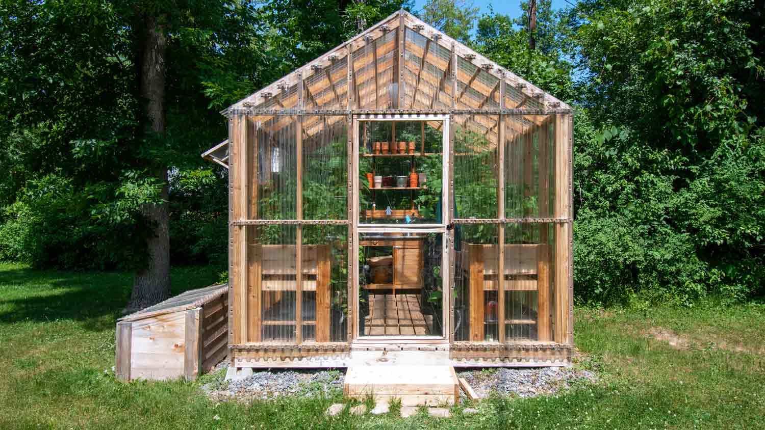 wooden greenhouse in yard