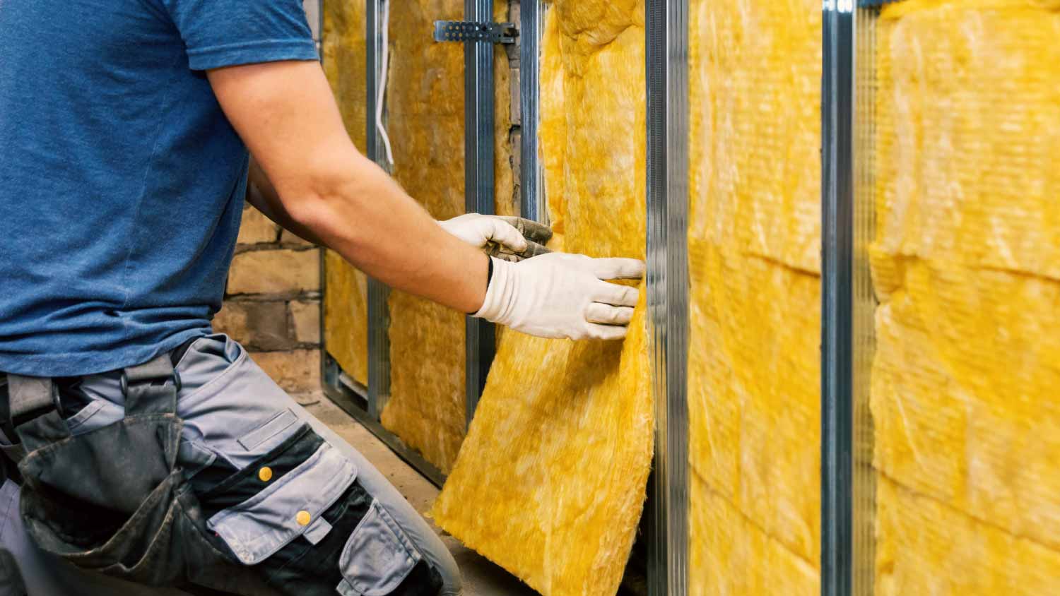 Worker installing glass wool