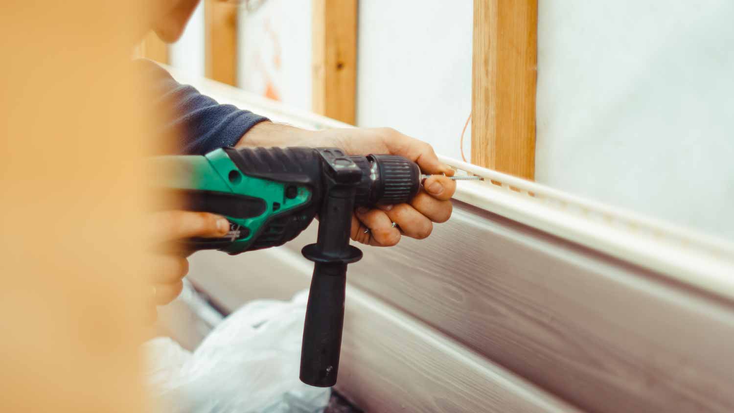 A worker installing panel siding