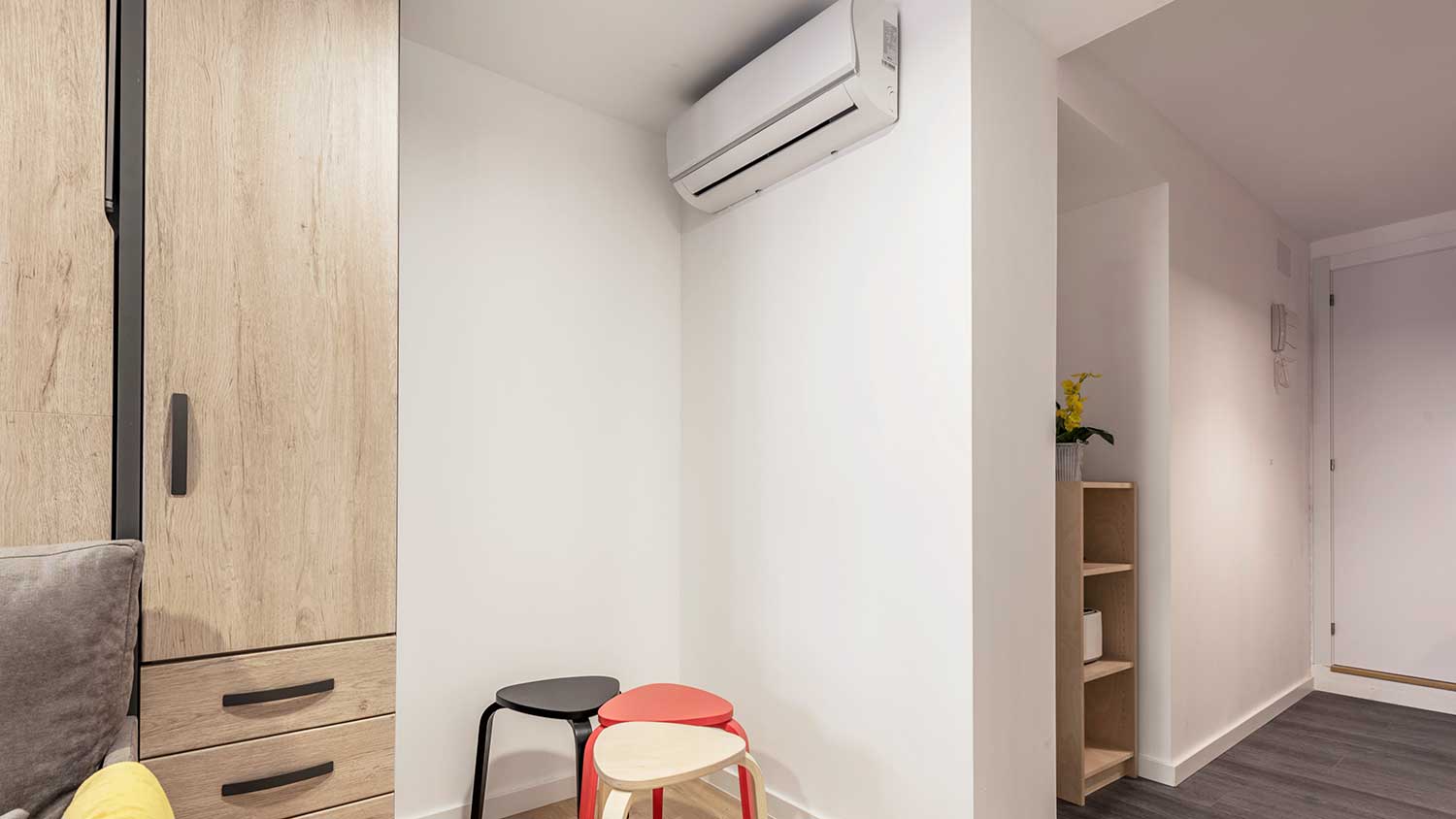 Mini-split unit mounted in a corner of a room