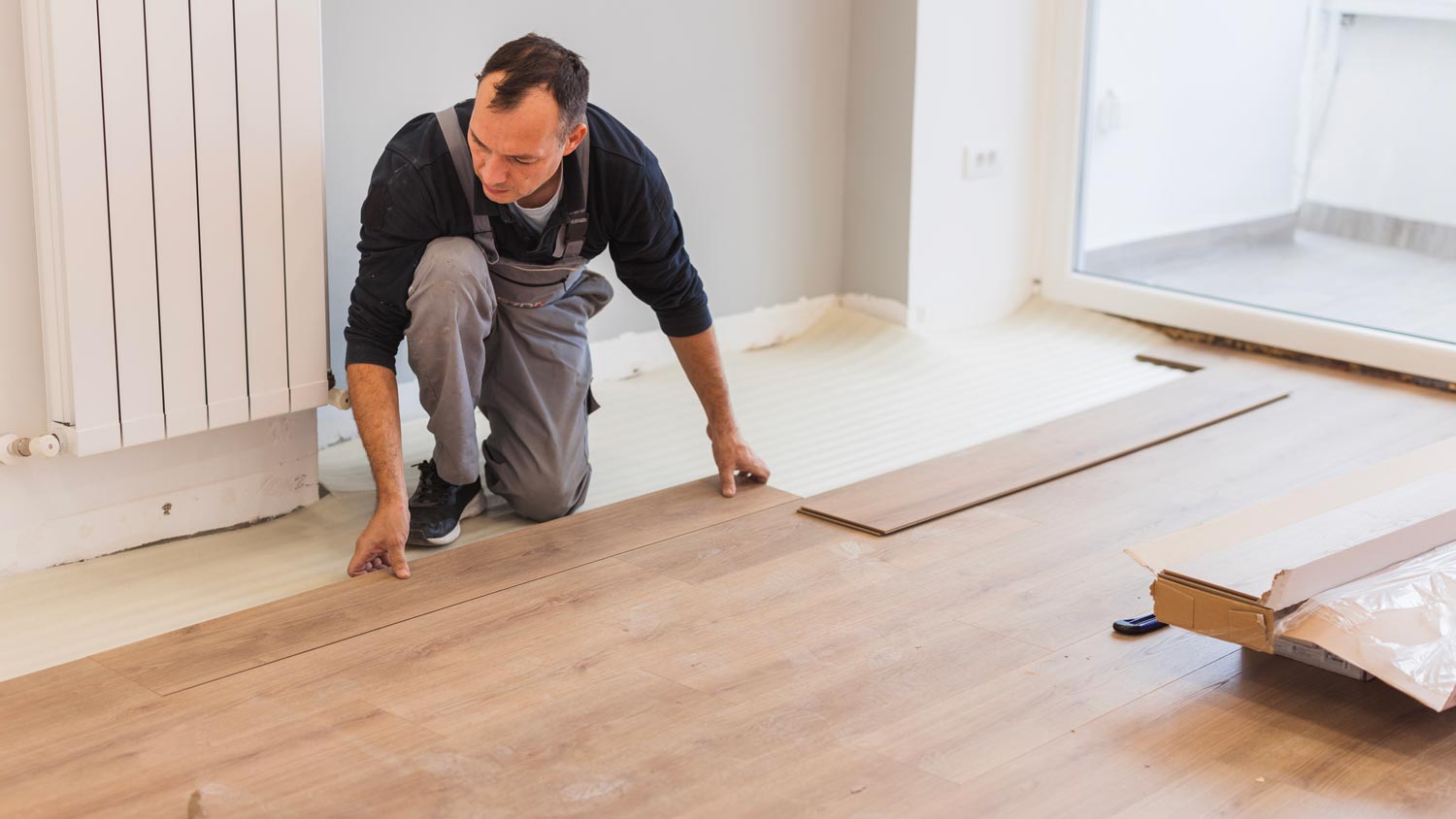 Carpenter adjusting hardwood floor