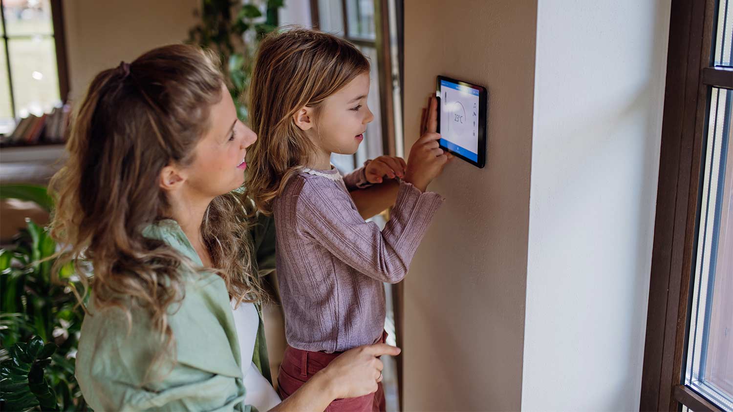 mother and child adjusting temperature in home