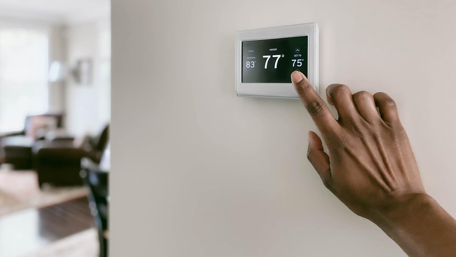 Adjusting the temperature on a home thermostat