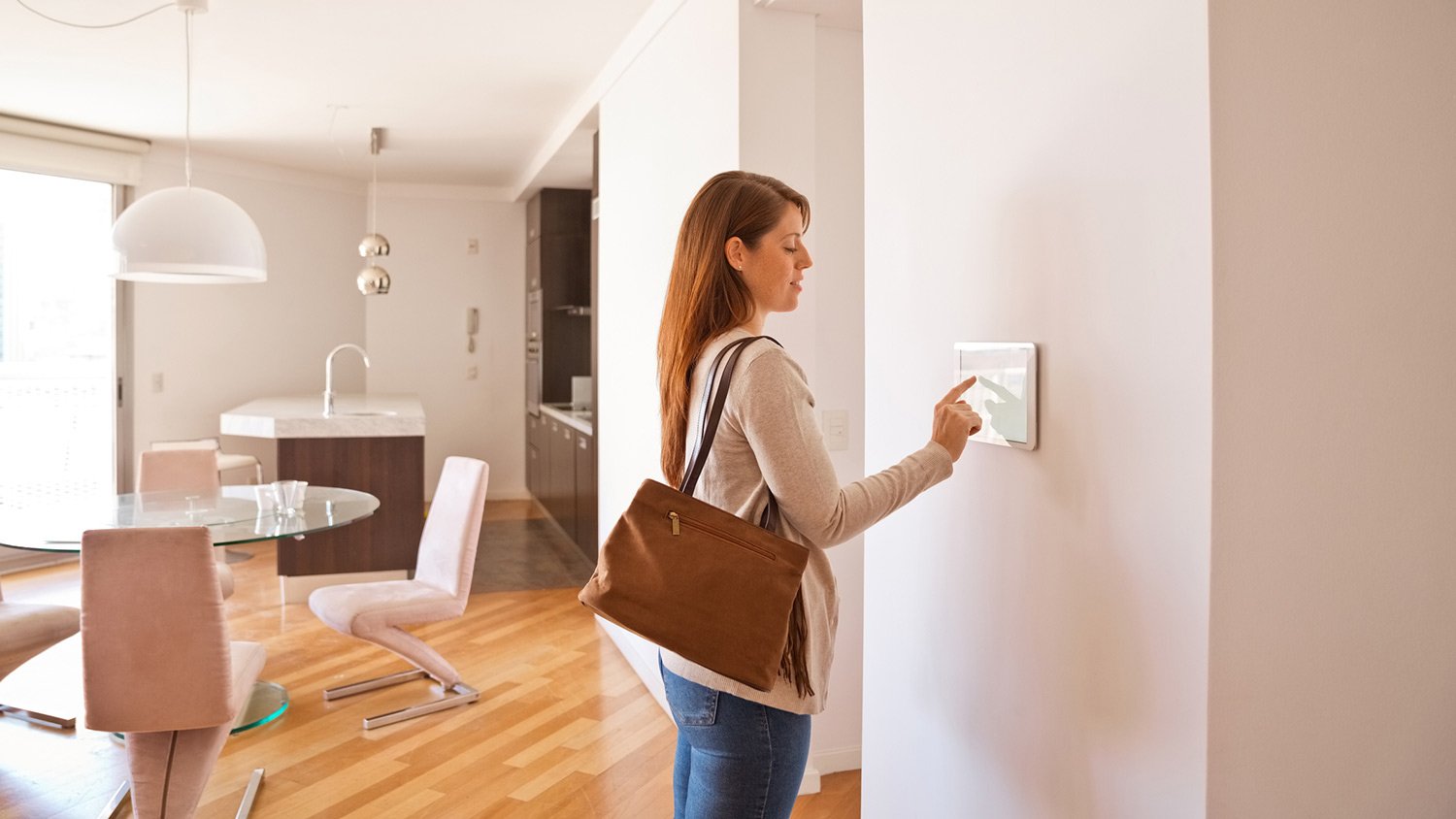 Woman adjusting thermostat