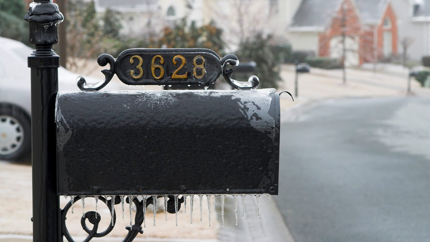 black mailbox with house number on the top