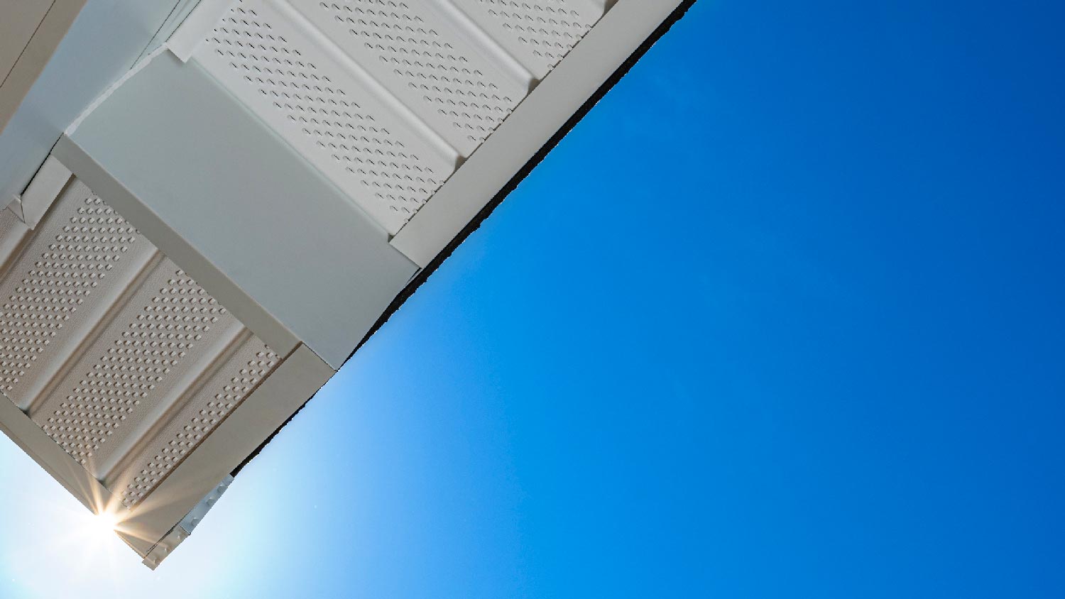 An aluminum soffit against the blue sky