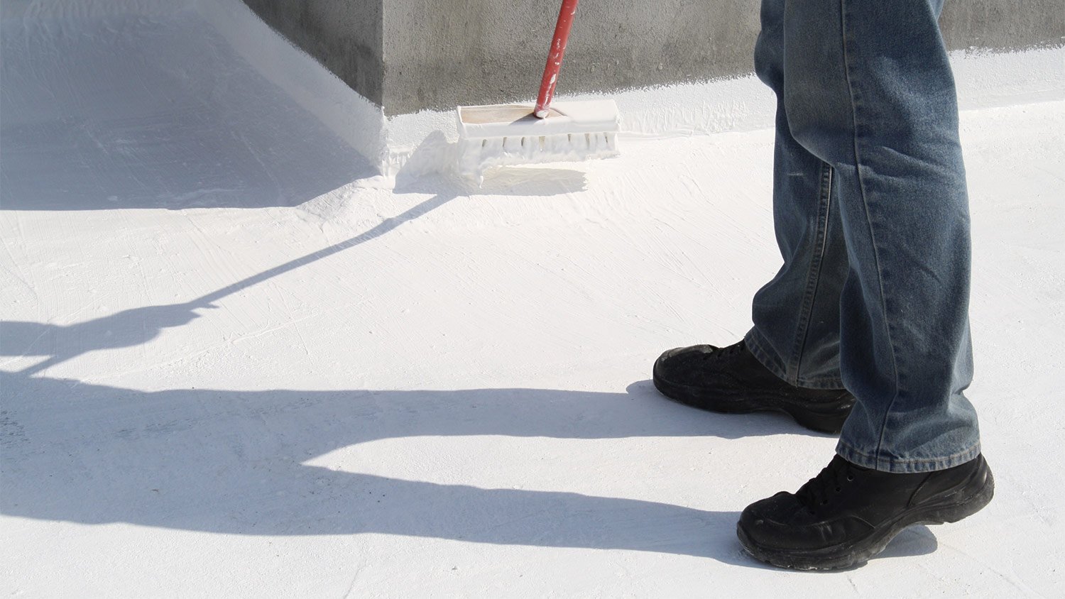 Applying white sealant on roof